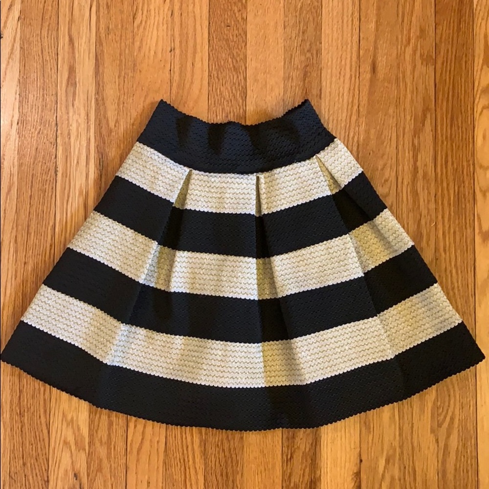 Black and gold pleated trumpet skirt.